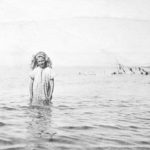 Young Idris standing thigh-deep in the Salish Sea at the foot of the Hall family property - Qualicum Beach, British Columbia, 1913.
